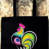 A black reusable tote bag featuring a vibrant