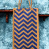 A medium-sized rectangular jute bag with a bold, repeating blue and natural jute chevron (zigzag) pattern.
