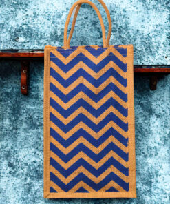 A medium-sized rectangular jute bag with a bold, repeating blue and natural jute chevron (zigzag) pattern.
