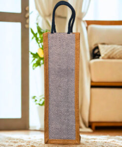 Jute bottle bag featuring a grey and white chevron patterned fabric front panel with blue rope handles.