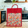 Red jute tote bag with colorful floral front panel and zipper pocket
