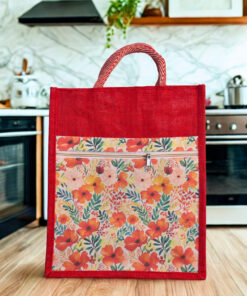 Red jute tote bag with colorful floral front panel and zipper pocket