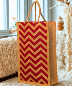 A medium-sized rectangular jute bag with a bold, repeating red and natural jute chevron (zigzag) pattern.