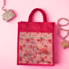 Bright pink jute bag with a floral flamingo print and front zipper pocket