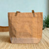 Plain natural jute tote bag with leather handles and a beige canvas base