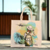 Canvas tote bag with a travel-themed print showing a woman with a backpack and an airplane flying overhead.