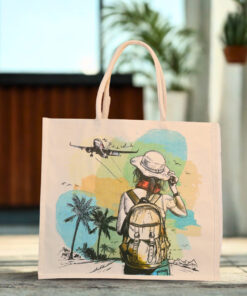 Canvas tote bag with a travel-themed print showing a woman with a backpack and an airplane flying overhead.