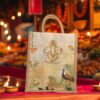 A jute tote bag featuring a printed design of Lord Ganesha