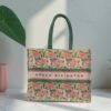 A canvas tote bag with a pink lotus flower print