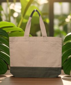 Natural canvas tote bag with a contrasting olive jute base and dual-toned sturdy handles.