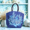 Natural jute tote bag with a large dark blue coral design on the front