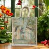 A canvas tote bag with thick woven handles and a detailed garden scene print featuring peacocks