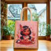 Kids jute bag featuring a cartoon girl with bird and teddy design on a pink background