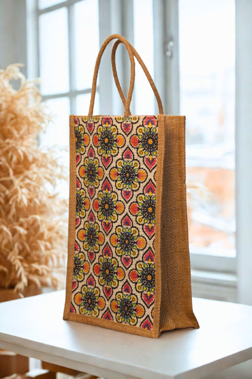 A medium-sized rectangular jute bag with a colorful, repeating geometric and floral-inspired pattern.