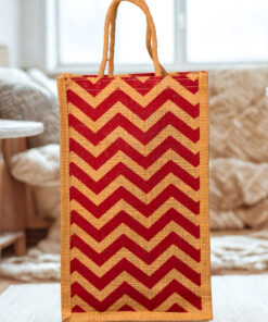 A medium-sized rectangular jute bag with a bold, repeating red and natural jute chevron (zigzag) pattern.
