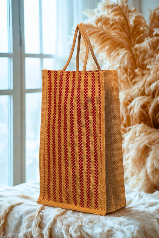 A medium-sized rectangular jute bag with a woven pattern of alternating natural jute and red vertical stripes.
