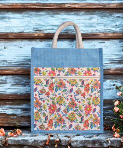 Blue jute bag featuring a colorful floral print and front zipper pocket with sturdy rope handles.