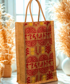 A medium-sized rectangular jute bag featuring a traditional Indian folk art print in red and yellow on a natural jute background.